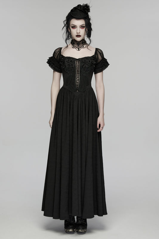 Woman wearing a black gothic-style dress on a gray background