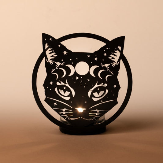 Alchemy Gothic Black cat-shaped tealight holder with star and moon designs on a beige background