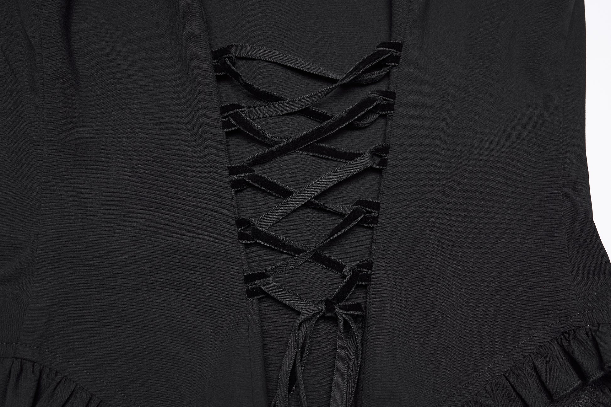 Detailed view of the goth ruffle shirt's lace-up design and ruffled hemline.