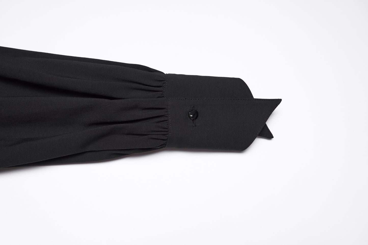 Detail of the sleeve and collar of the Punk Rave Nyx Asymmetrical Shirt Dress in black fabric.