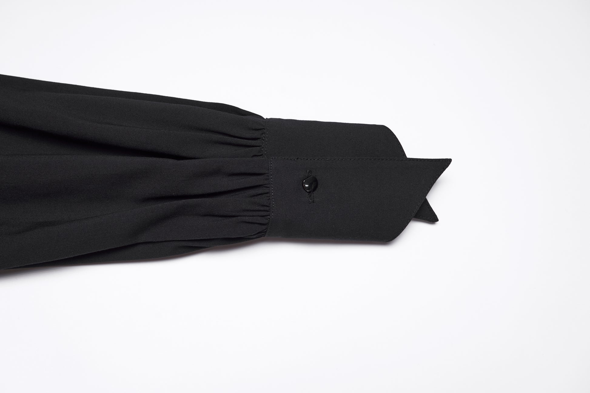 Detail of the sleeve and collar of the Punk Rave Nyx Asymmetrical Shirt Dress in black fabric.