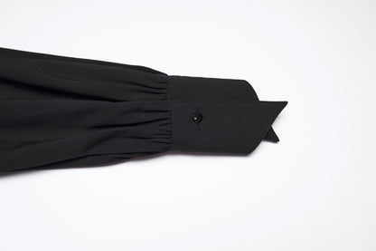 Detail of the sleeve and collar of the Punk Rave Nyx Asymmetrical Shirt Dress in black fabric.