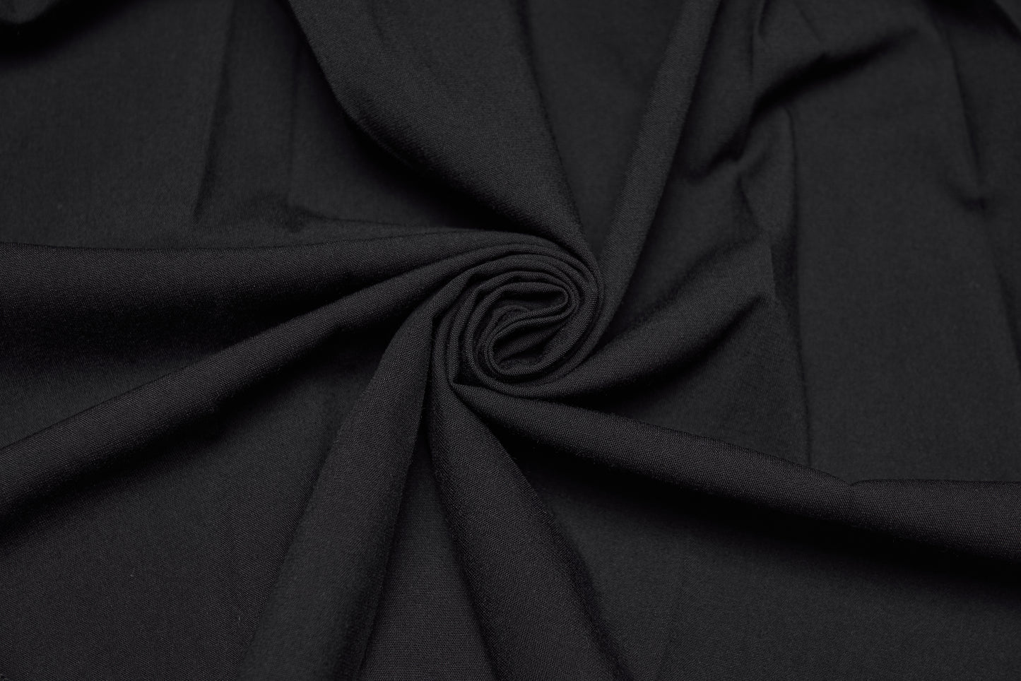 Close-up of black fabric showcasing soft texture, perfect for the Punk Rave Nyx Asymmetrical Shirt Dress.