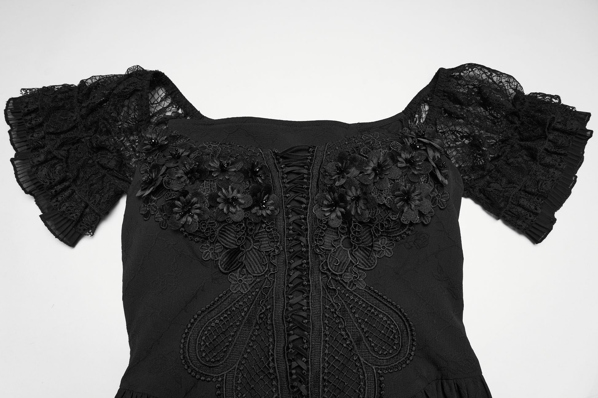 Detail of the goth maxi dress featuring lace accents and floral embellishments on the bodice.