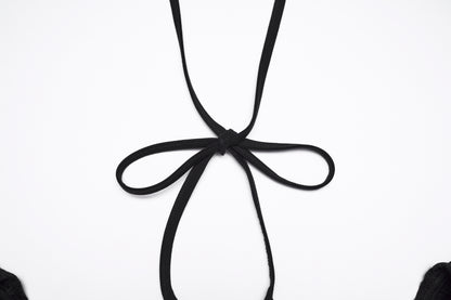 Close-up of the back detail of the Punk Rave Morrigan goth flying sleeve dress featuring a black ribbon tie.