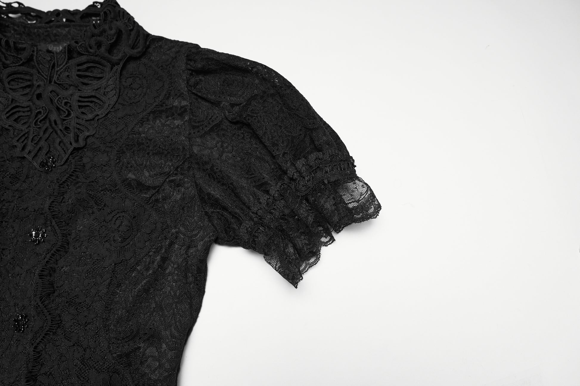 Close-up of lace goth shirt showcasing intricate lace detailing and puff sleeve design.