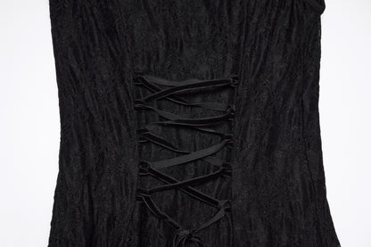 Close-up of the back detail of a goth flying sleeve dress with lace-up design in black fabric.