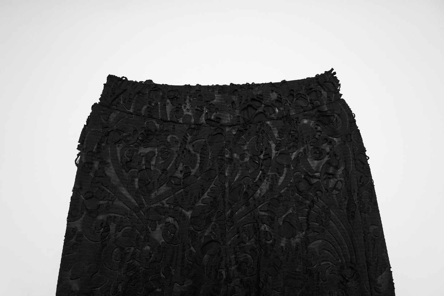 Punk Rave Morticia Jacquard Flared Pants close-up view of textured black fabric with intricate design.
