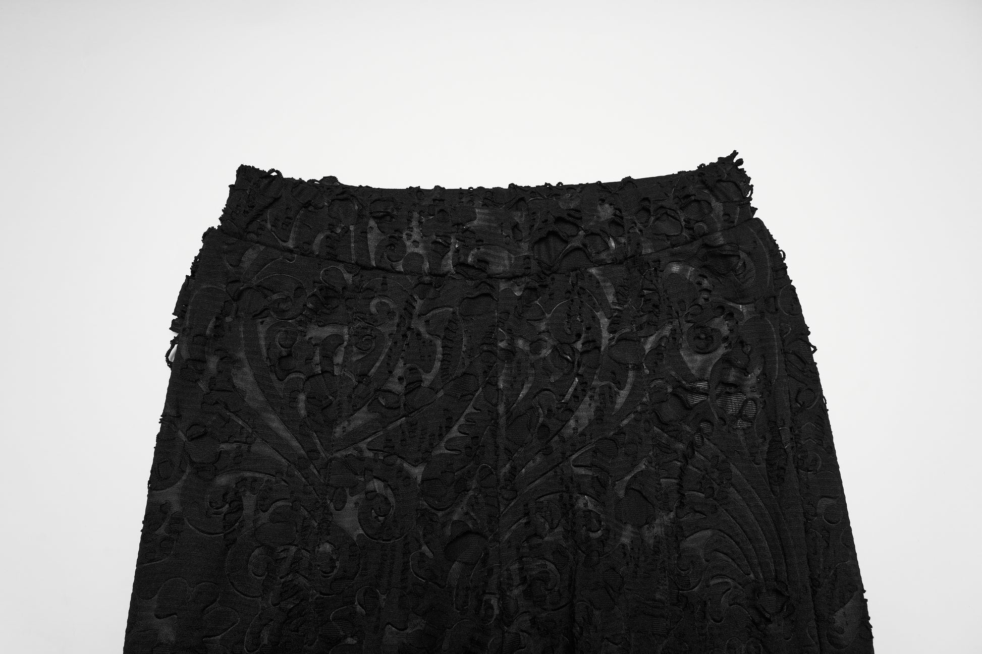 Punk Rave Morticia Jacquard Flared Pants close-up view of textured black fabric with intricate design.