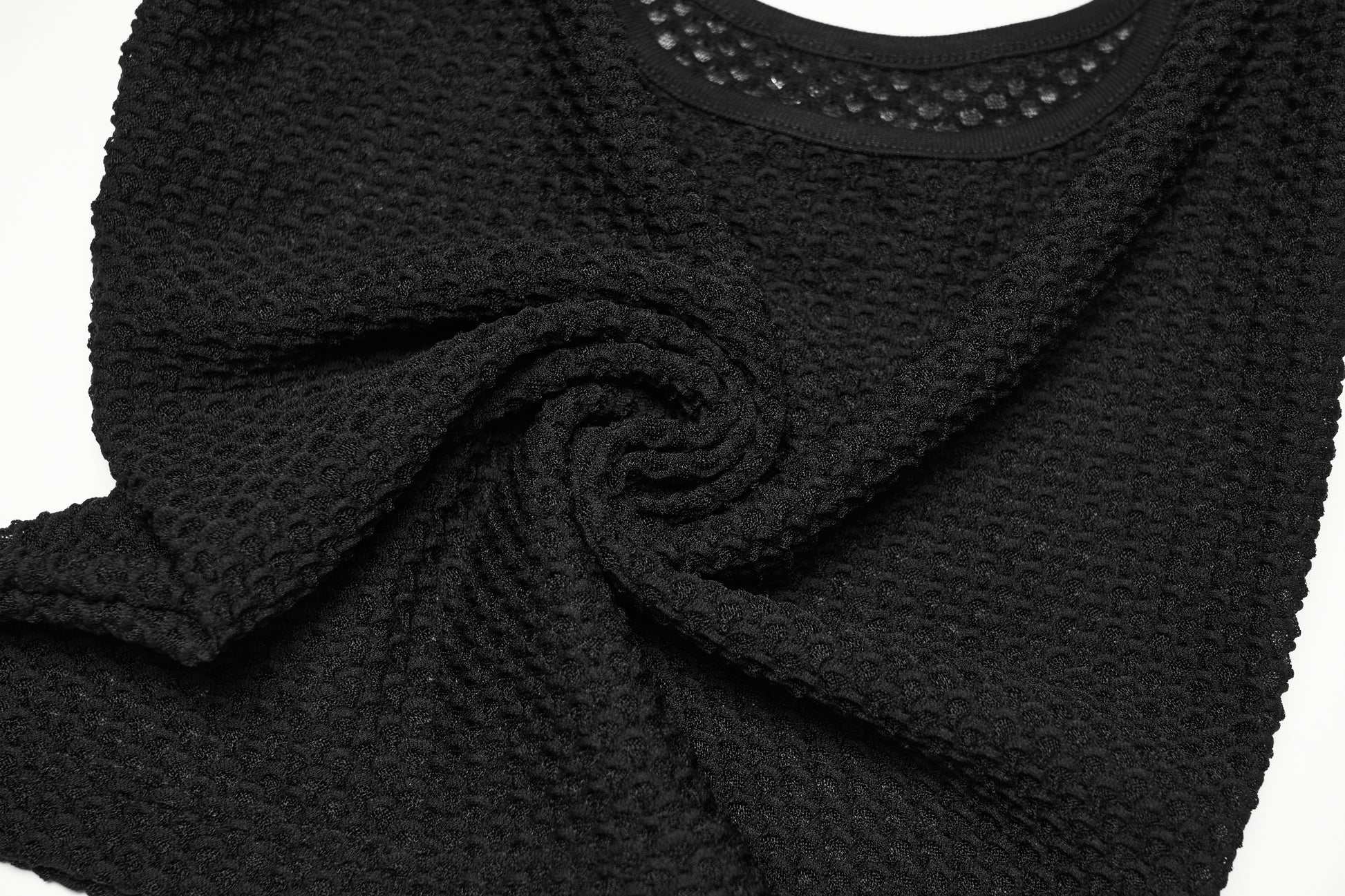 Close-up of a black mesh goth camisole showcasing textured fabric and a sleek design.
