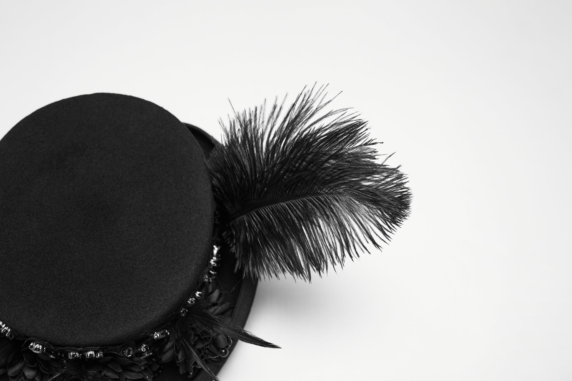 Goth feather formal hat with dramatic feather detail and floral embellishments for gothic fashion.
