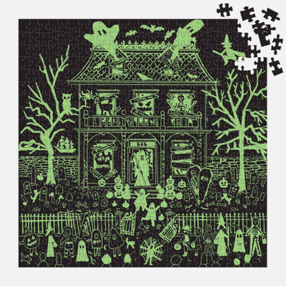 The same puzzle in the dark, with the house, trees and figures glowing green.