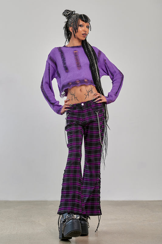 Model wearing Banned Apparel Purple Tartan Trousers front view scarlett vixen purple black tartan punk trousers with chains
