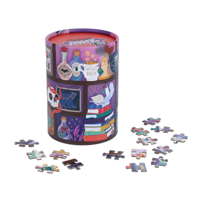 The puzzle tube standing beside loose jigsaw pieces on a white background.