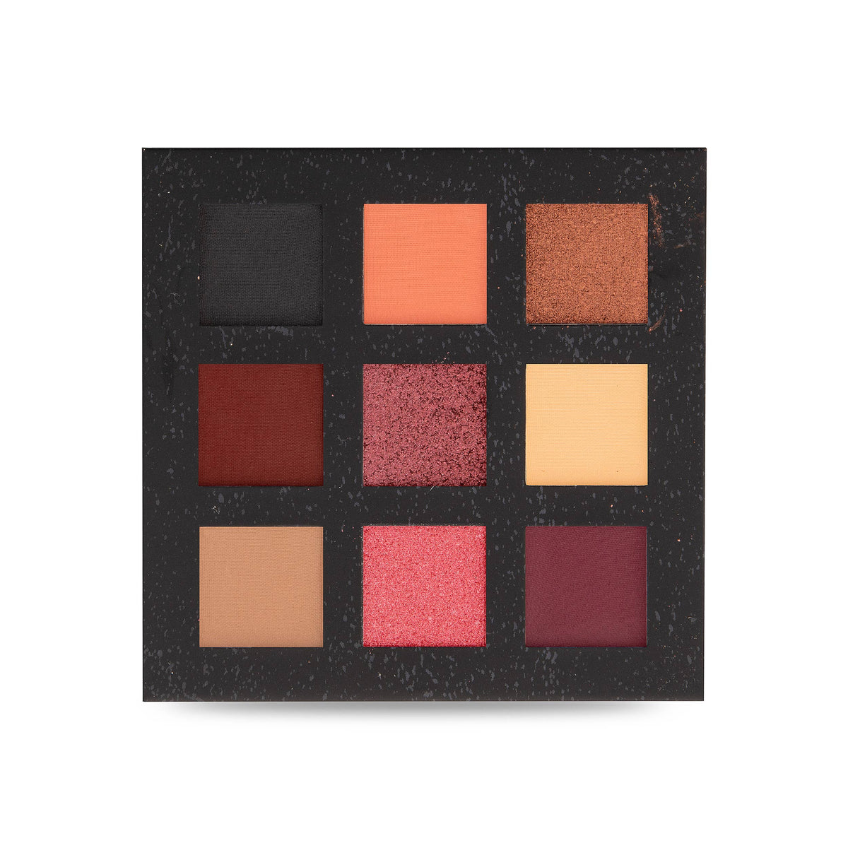 Close-up of the eyeshadow pans, showing warm-toned shades in reds, oranges, pinks and browns