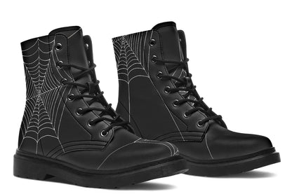 Black goth boots with spider web pattern on a white background