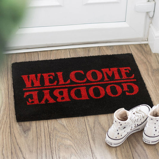 Gothic Doormat with red lettering that reads 'WELCOME' and 'GOODBYE' on a black background.