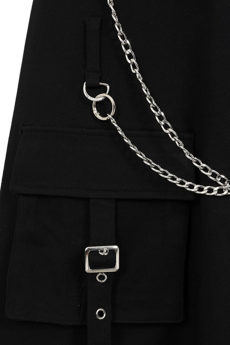 Close-up of gothic cargo skirt pocket and chain detail, showcasing punk style and unique design features.