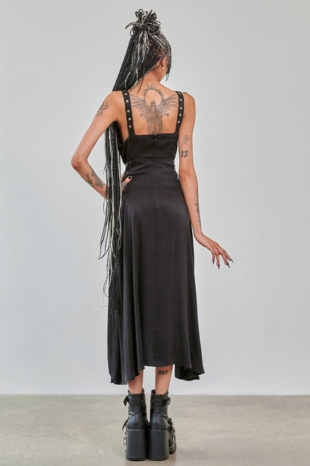 Gothic High Low Dress black asymmetric design with studded straps and a flowing skirt from back view.
