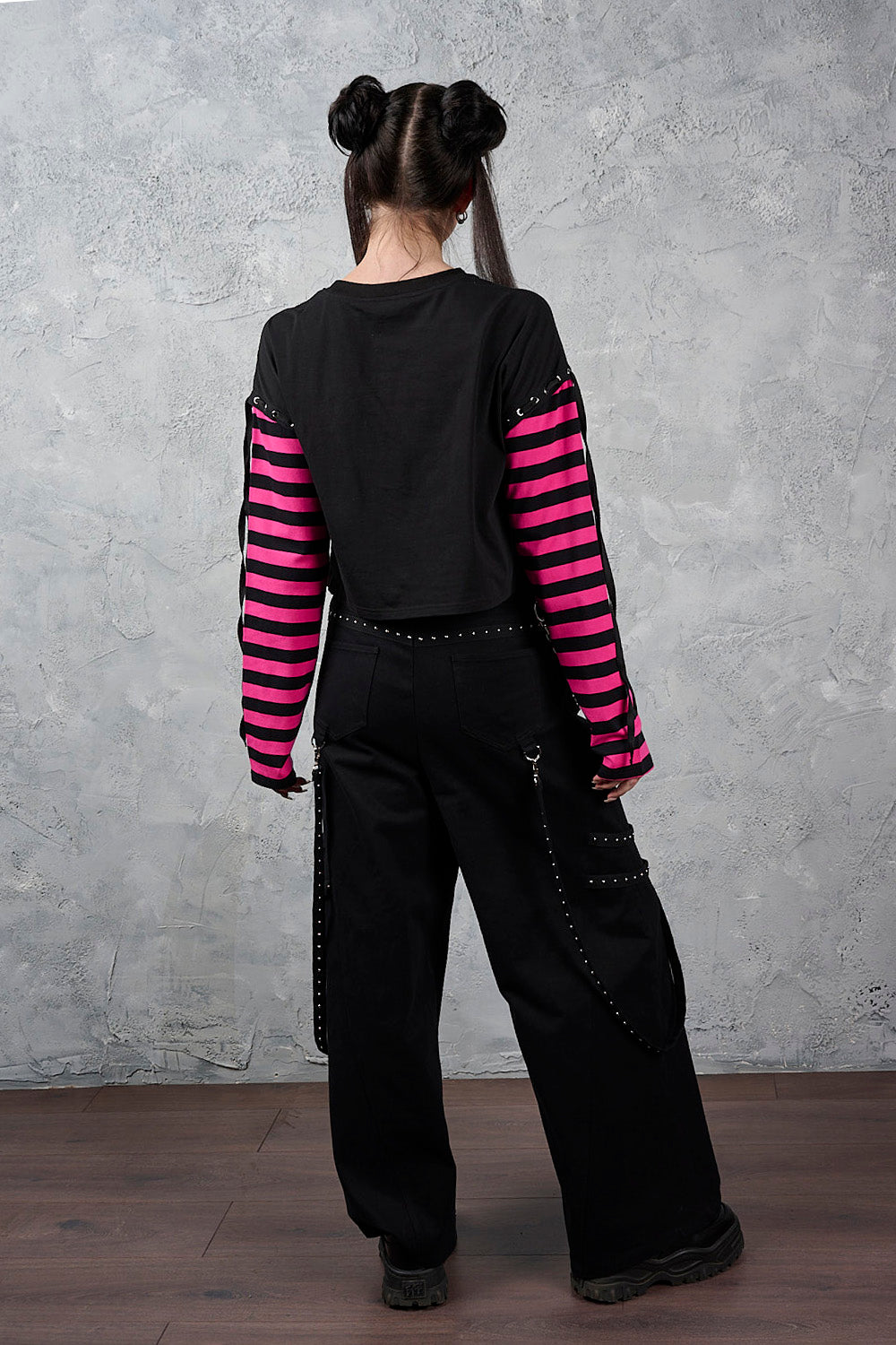 Banned Apparel Hangfire wide leg black alt trousers, cargo style with straps and metal hardware back view on a model