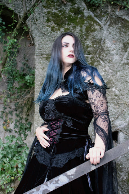 Angelineva_ wearing Dark in Love Gothic Velvet Corset Top stood against a stone wall