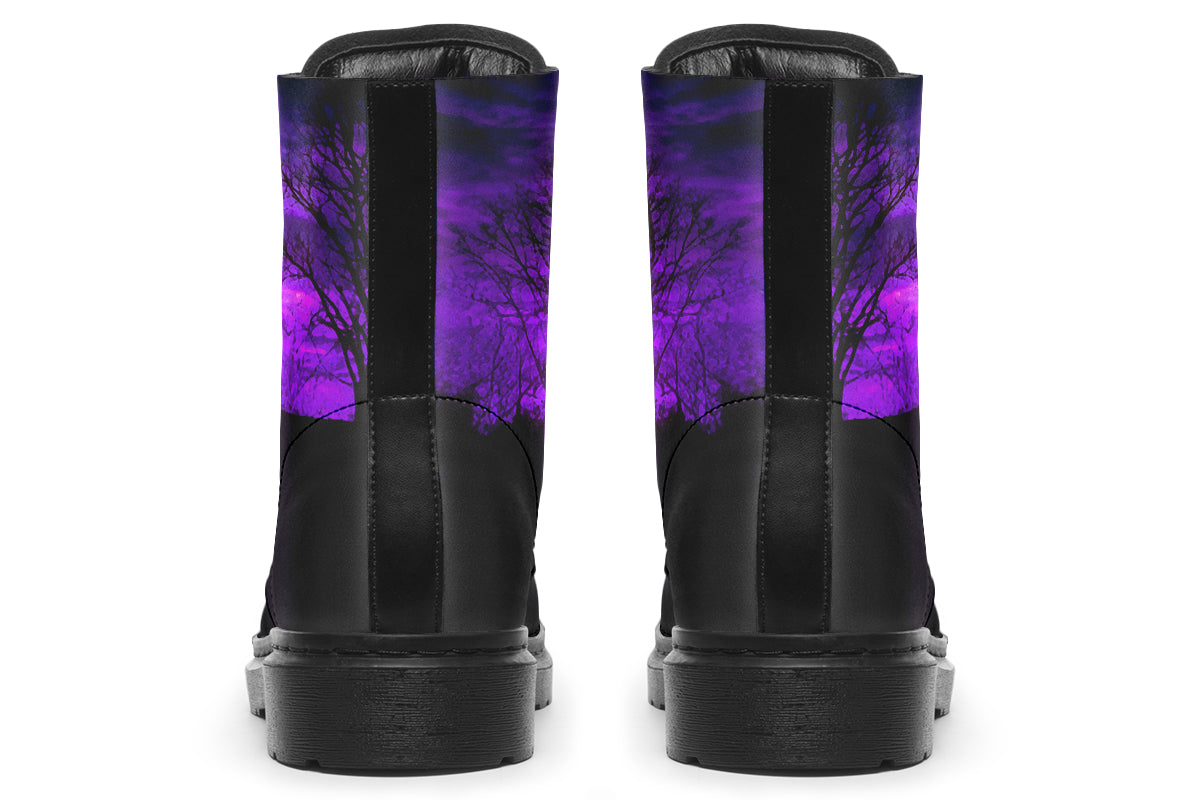 Black boots with a purple tree design on a white background