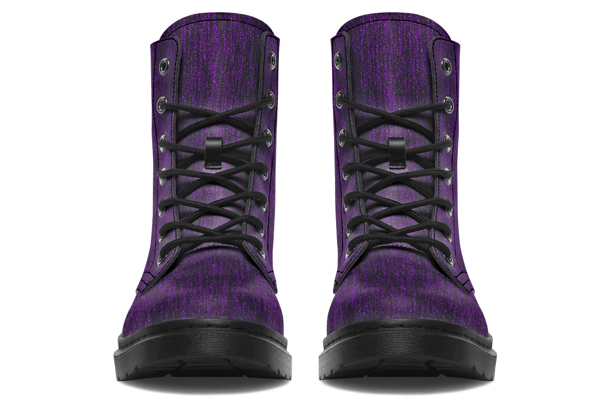 Pair of purple boots with black laces on a white background