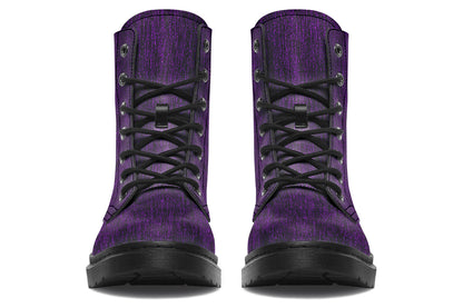 Pair of purple boots with black laces on a white background