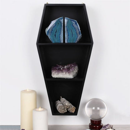 Coffin Shelving Display shown displaying crystal and smudge sticks next to lit candles and a crystal ball