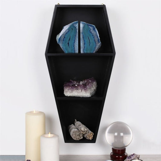 Coffin Shelving Display shown displaying crystal and smudge sticks next to lit candles and a crystal ball
