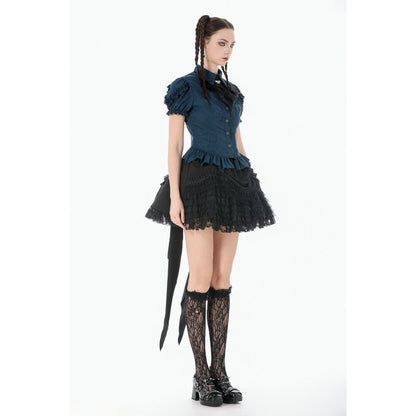 Person wearing a dark blue top and black lace skirt with stockings and shoes on a white background