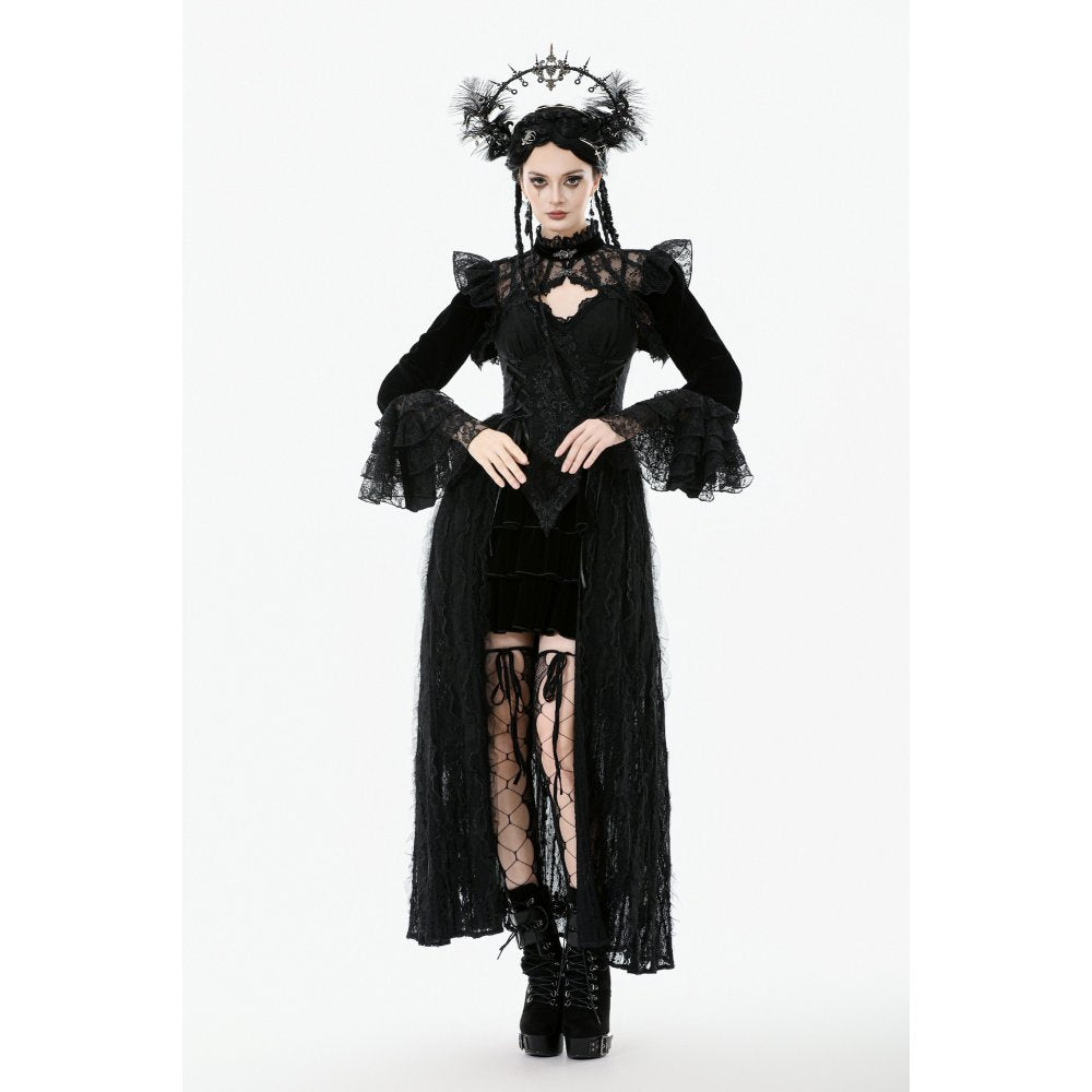 Person wearing a black gothic outfit with ruffled sleeves and a headpiece on a white background