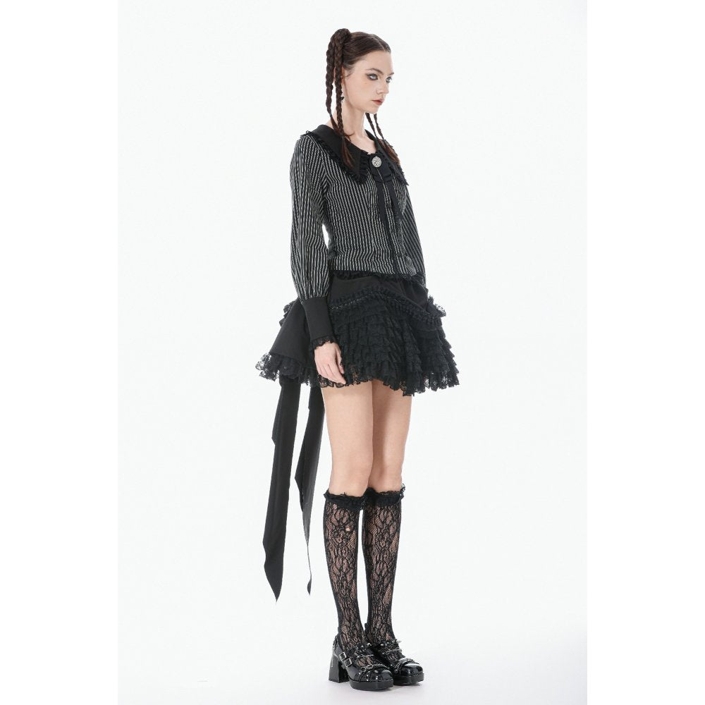 Person wearing a gothic-style outfit with a lace top, skirt, and stockings on a white background
