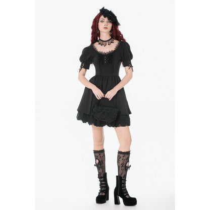Woman wearing a black lace dress with matching accessories on a white background
