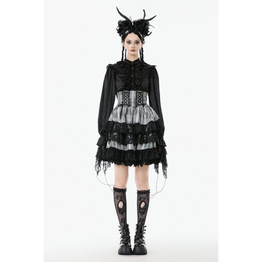 Person wearing a black and white gothic outfit with lace details on a white background