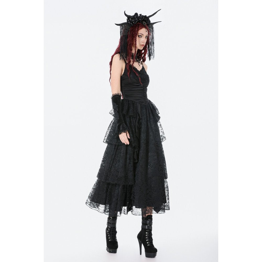 Person wearing a black gothic dress with lace details on a white background