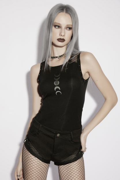 Model wearing a goth moon vest with moon phase print, paired with shorts and fishnet stockings, showcasing alternative fashion style.