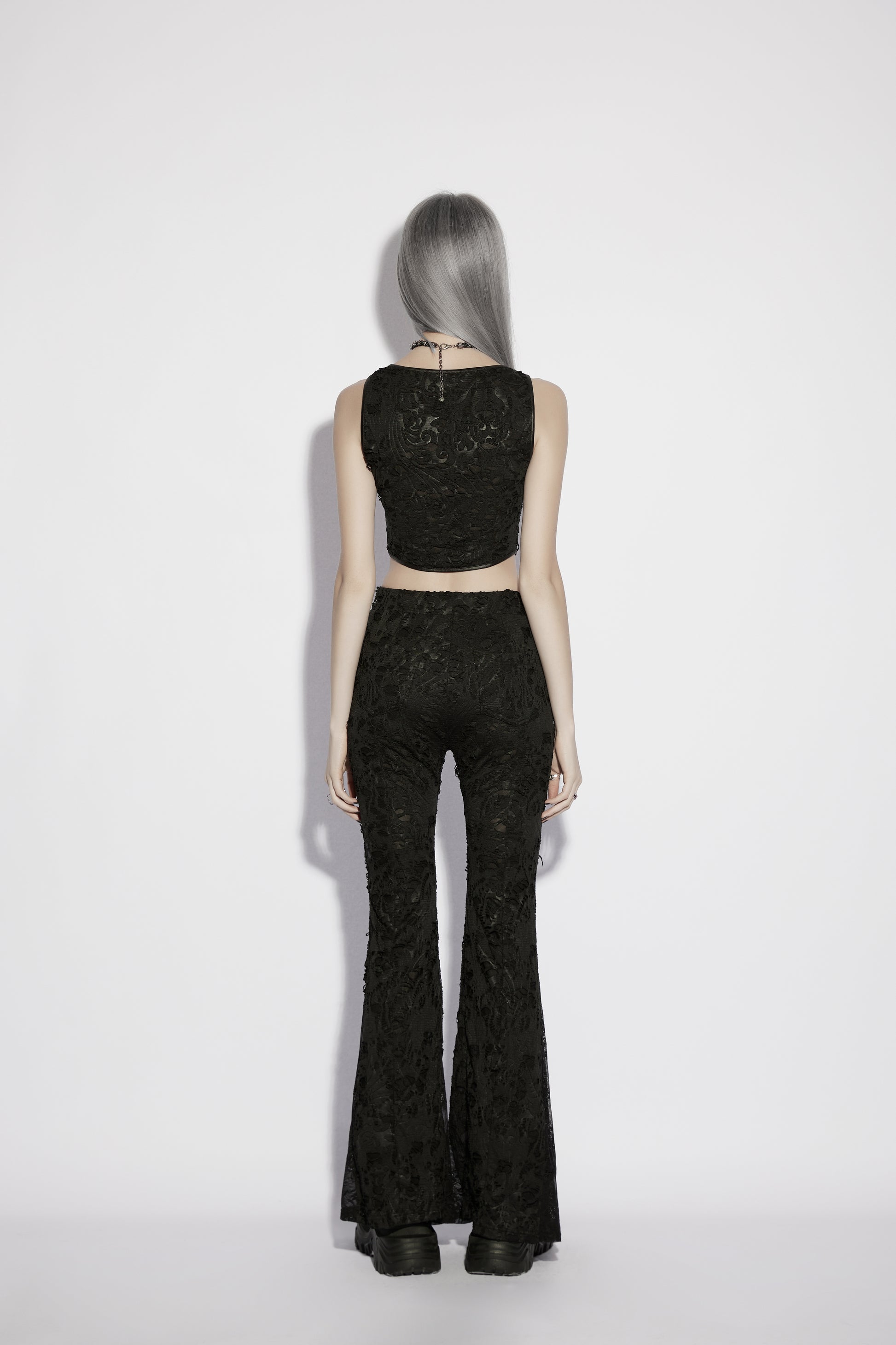 Model wearing Punk Rave Morticia Jacquard Flared Pants and a black crop top from the back, showcasing dark elegance.
