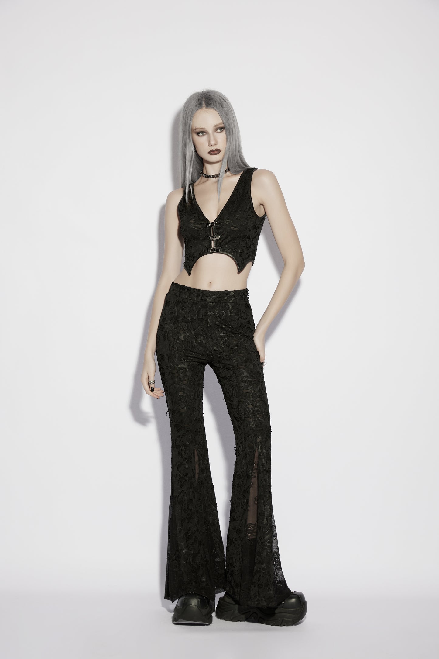 Model wearing Punk Rave Morticia Jacquard Flared Pants and a cropped top, showcasing a dark, elegant goth style.