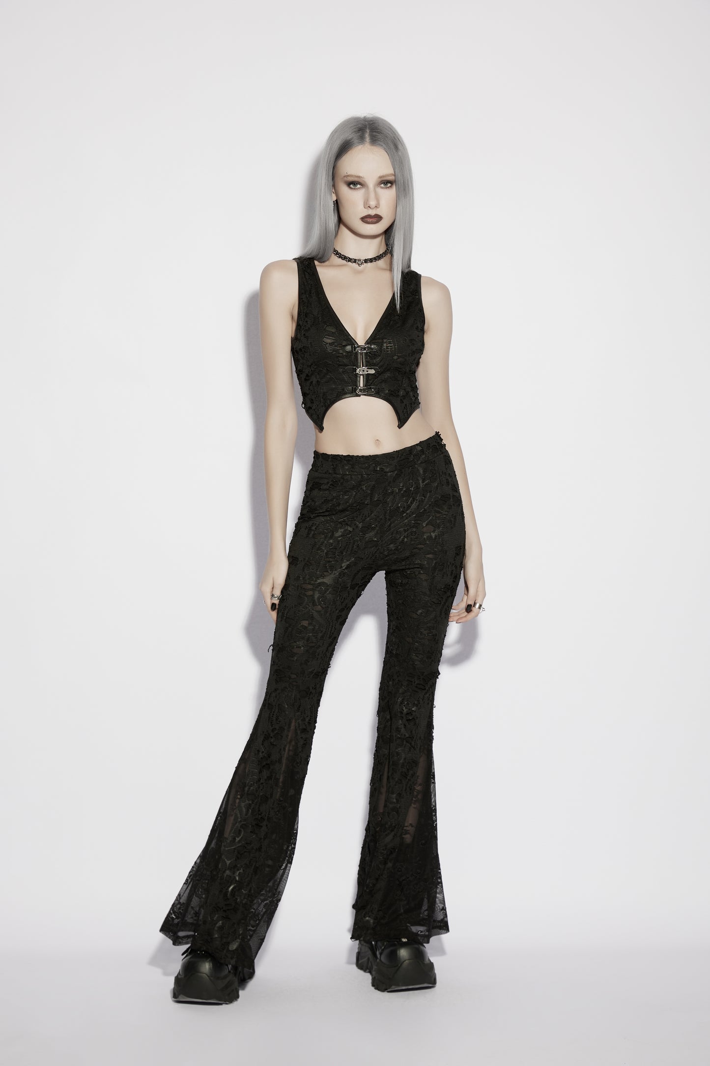 Model wearing Punk Rave Morticia Jacquard Flared Pants paired with a stylish crop top in a striking gothic aesthetic.