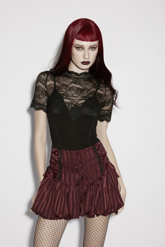 Model wearing a lace panel goth t shirt with a bold silhouette and layered floral design.