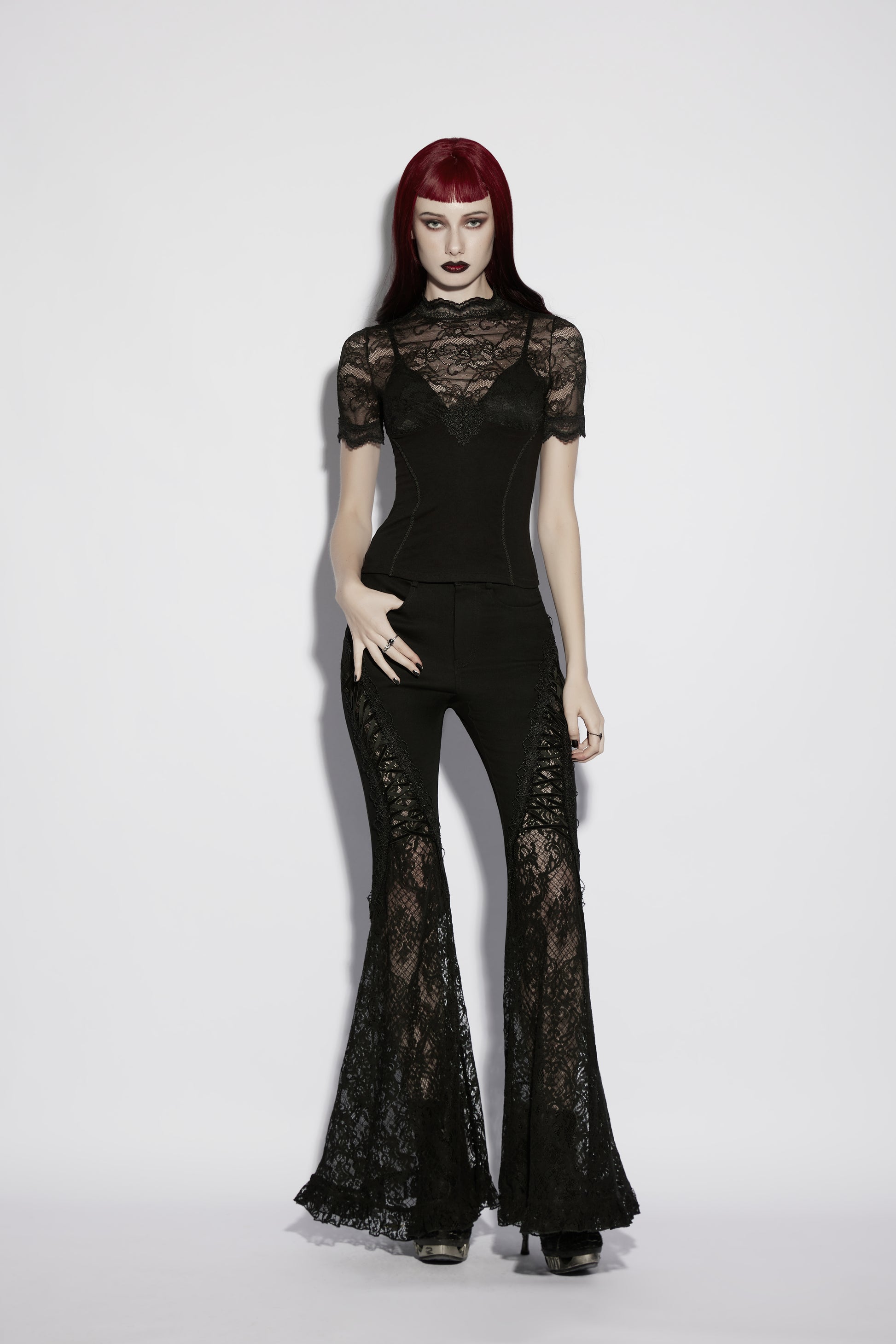 Model wearing a lace panel goth t shirt with flared lace pants, showcasing gothic elegance and intricate detailing.