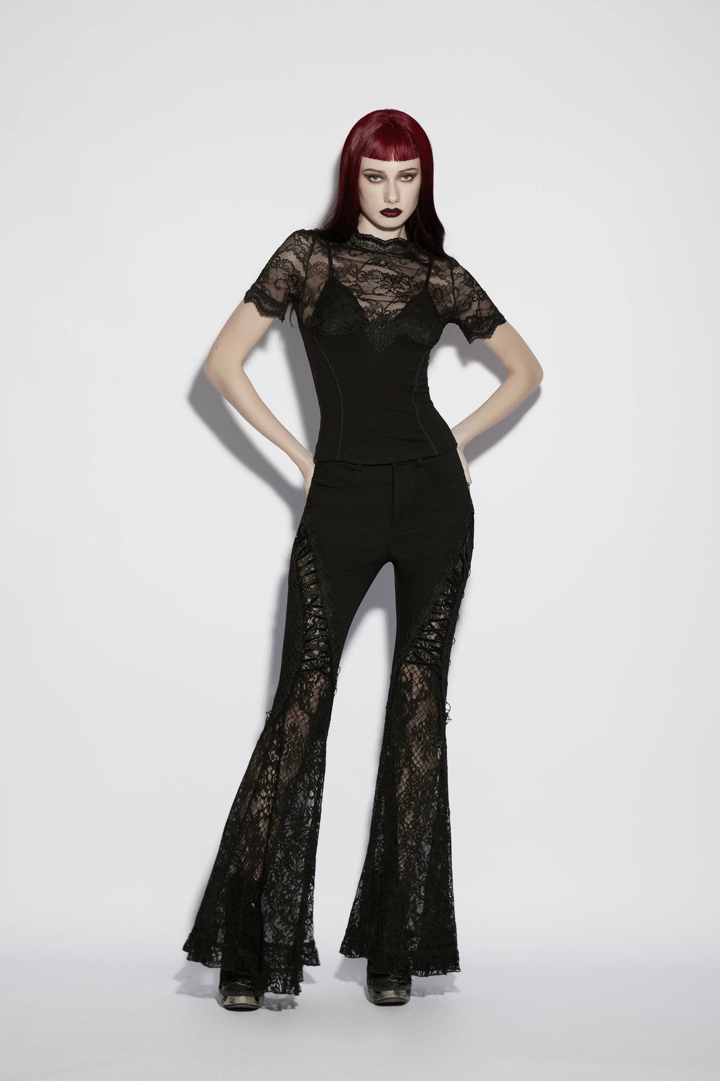 Model wearing a Punk Rave Elvira Lace Panel goth t shirt paired with flared lace pants.