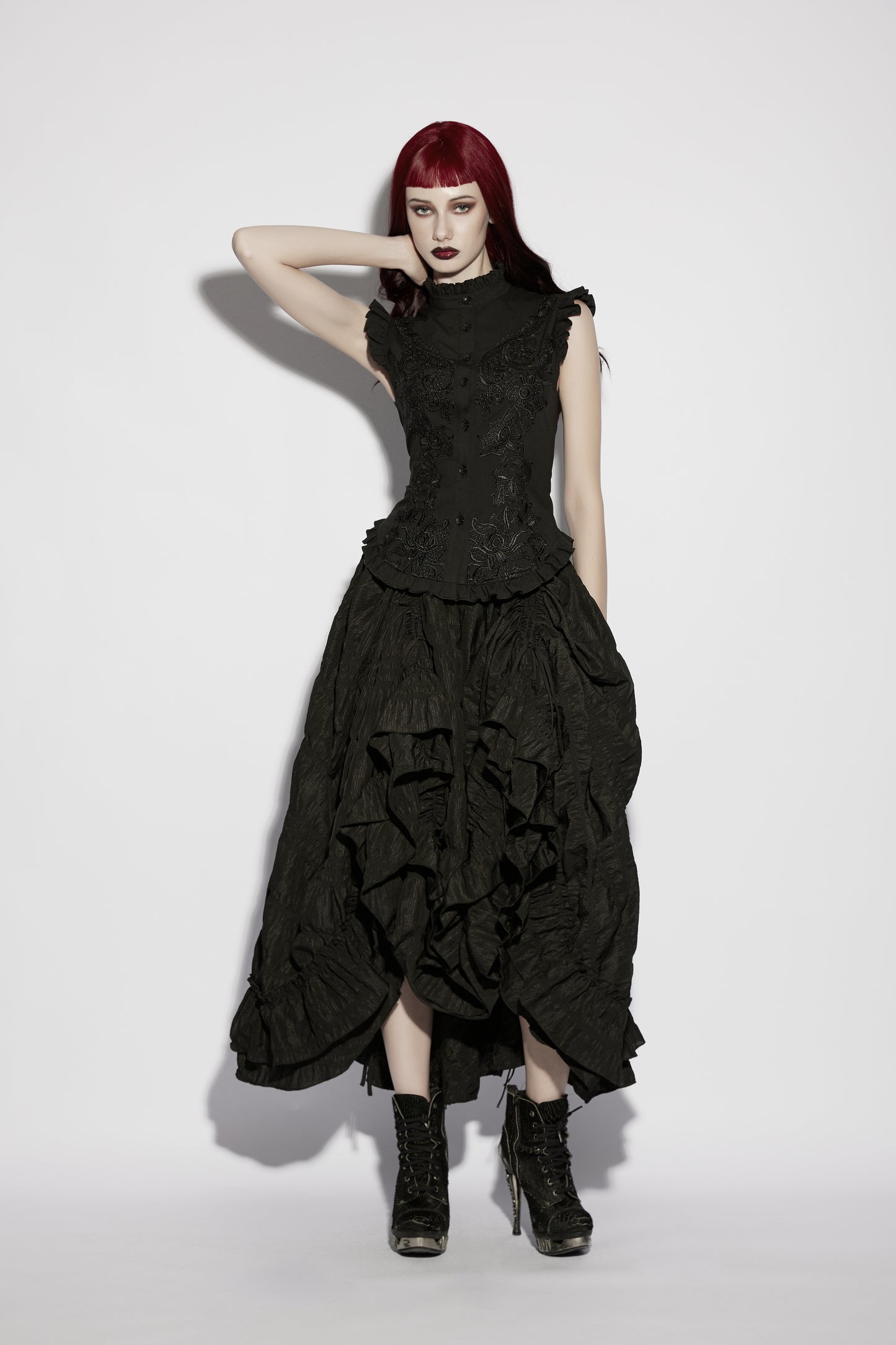 Model wearing a goth ruffle shirt paired with a flowing black skirt, showcasing gothic elegance and vintage-inspired style.
