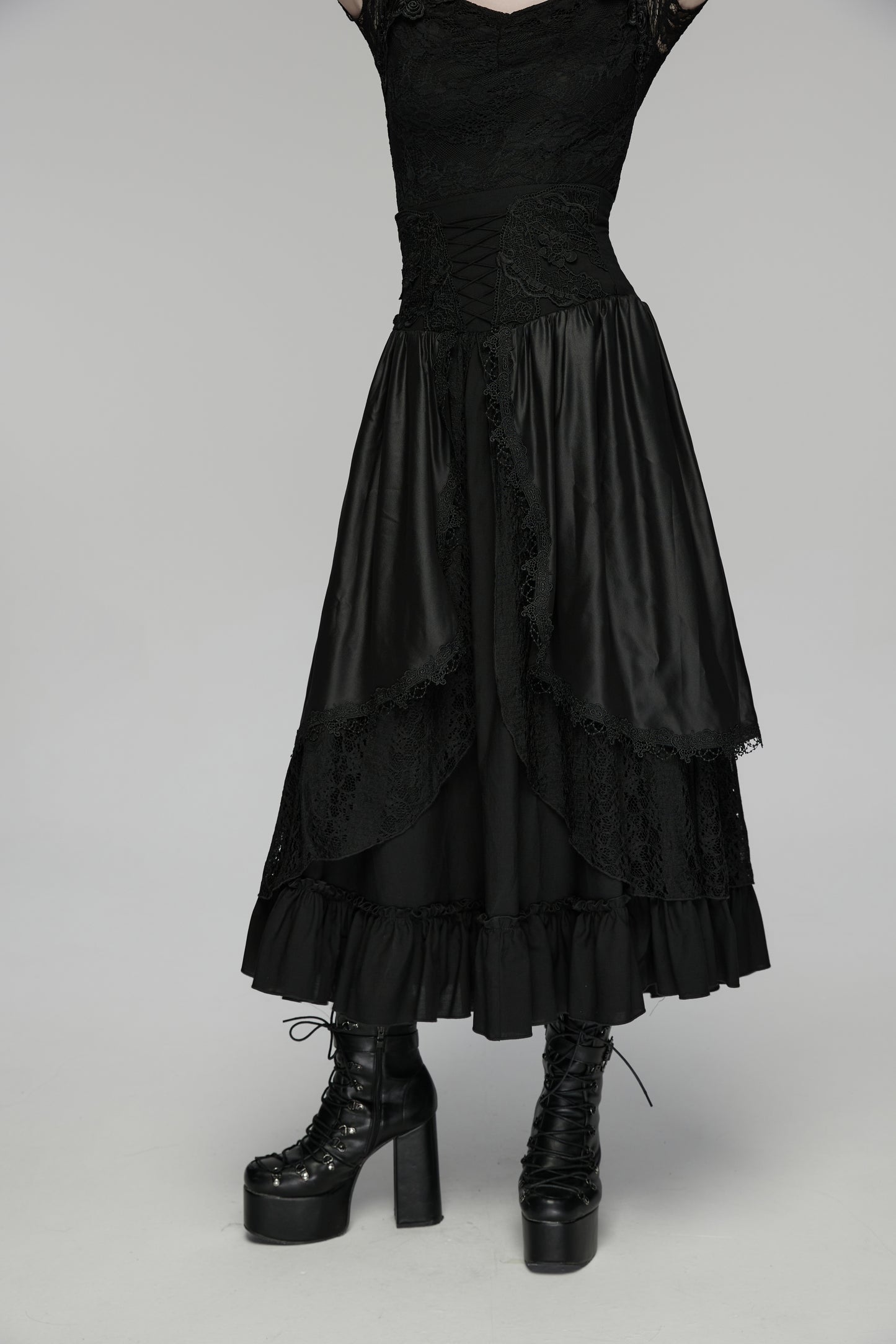 Goth layered skirt with flowing layers and dark romantic texture, paired with chunky black platform boots.