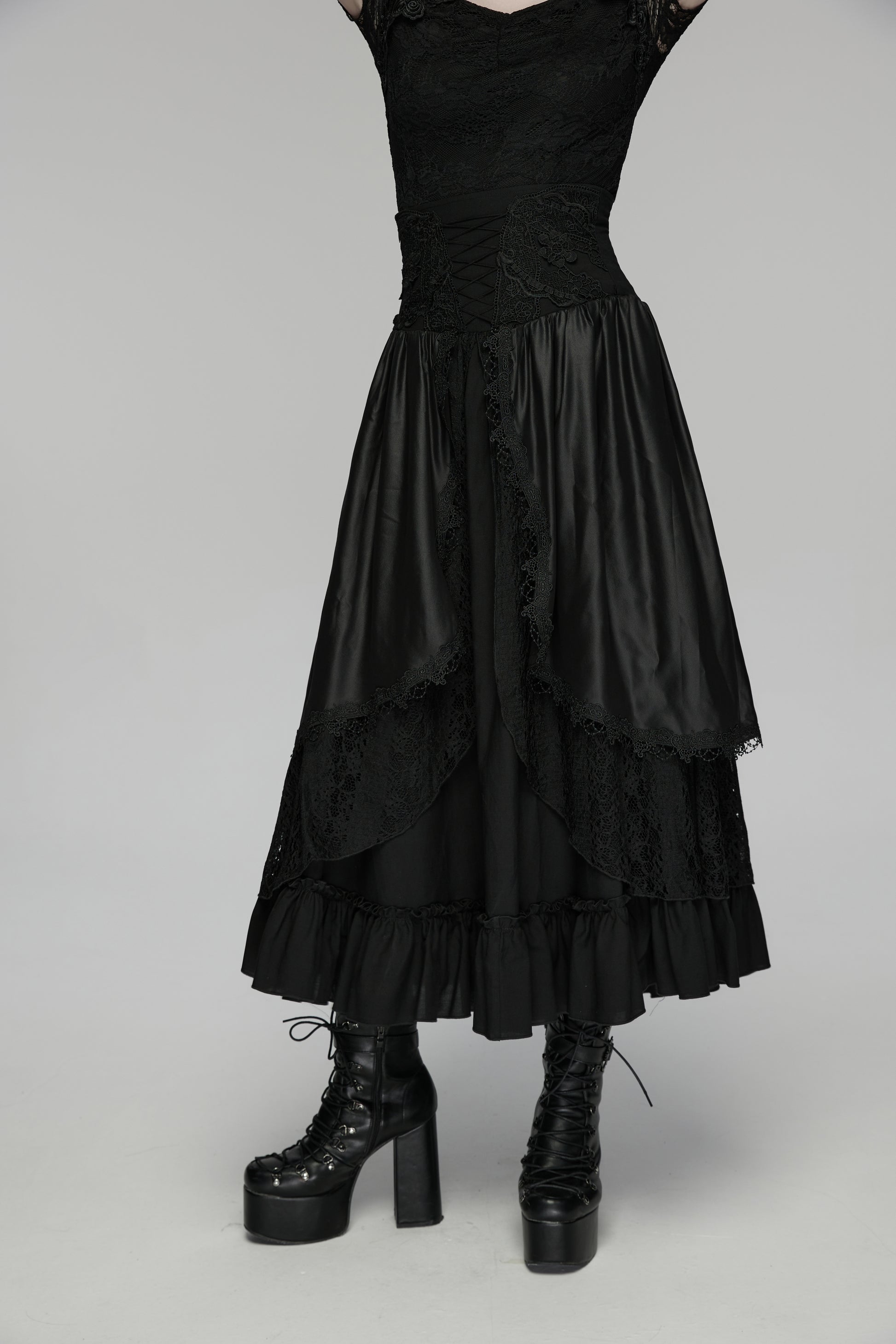 Goth layered skirt with flowing layers and dark romantic texture, paired with chunky black platform boots.