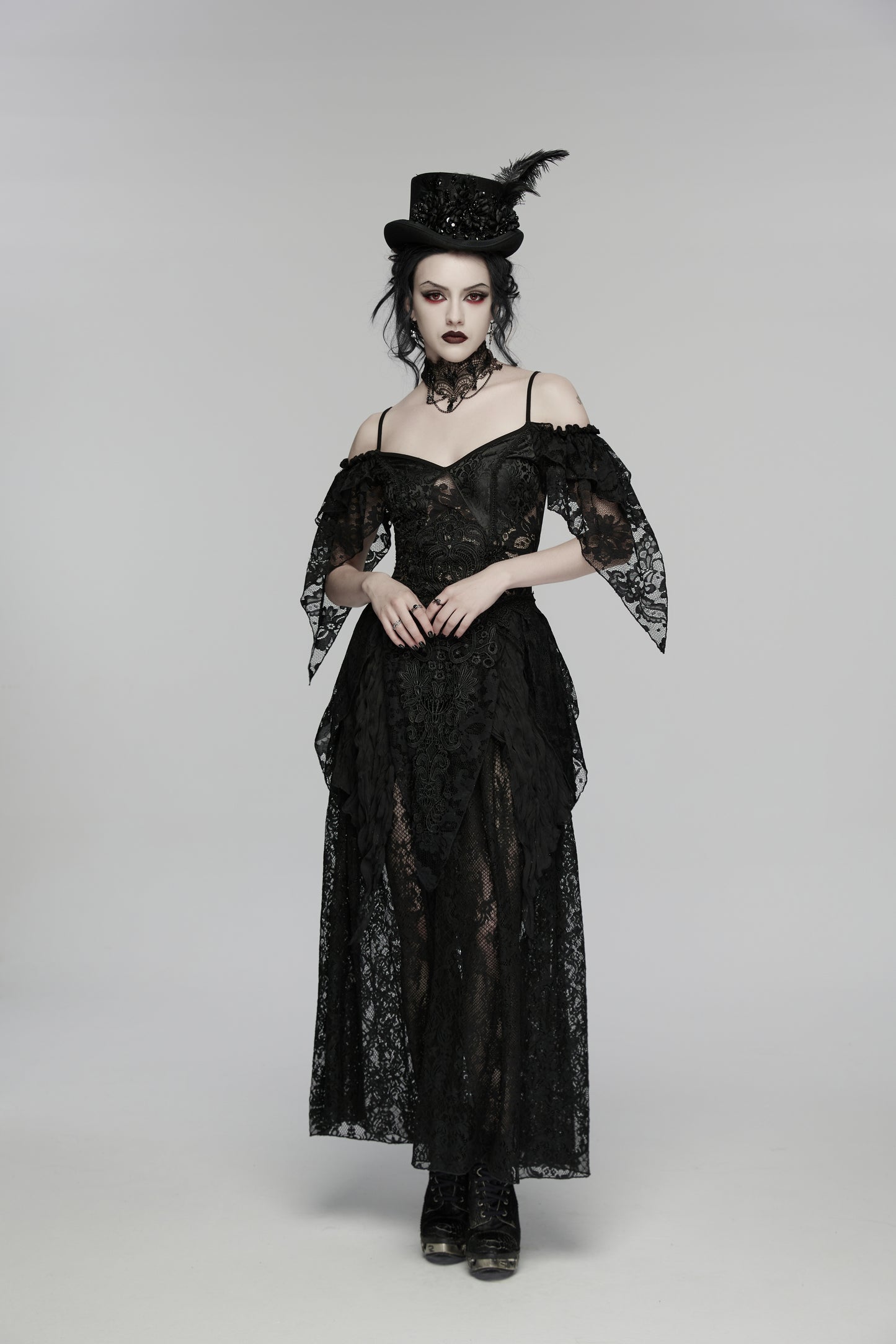Model wearing Punk Rave Goth Retro Feather Formal Hat with black lace gown and dark makeup in a gothic setting.
