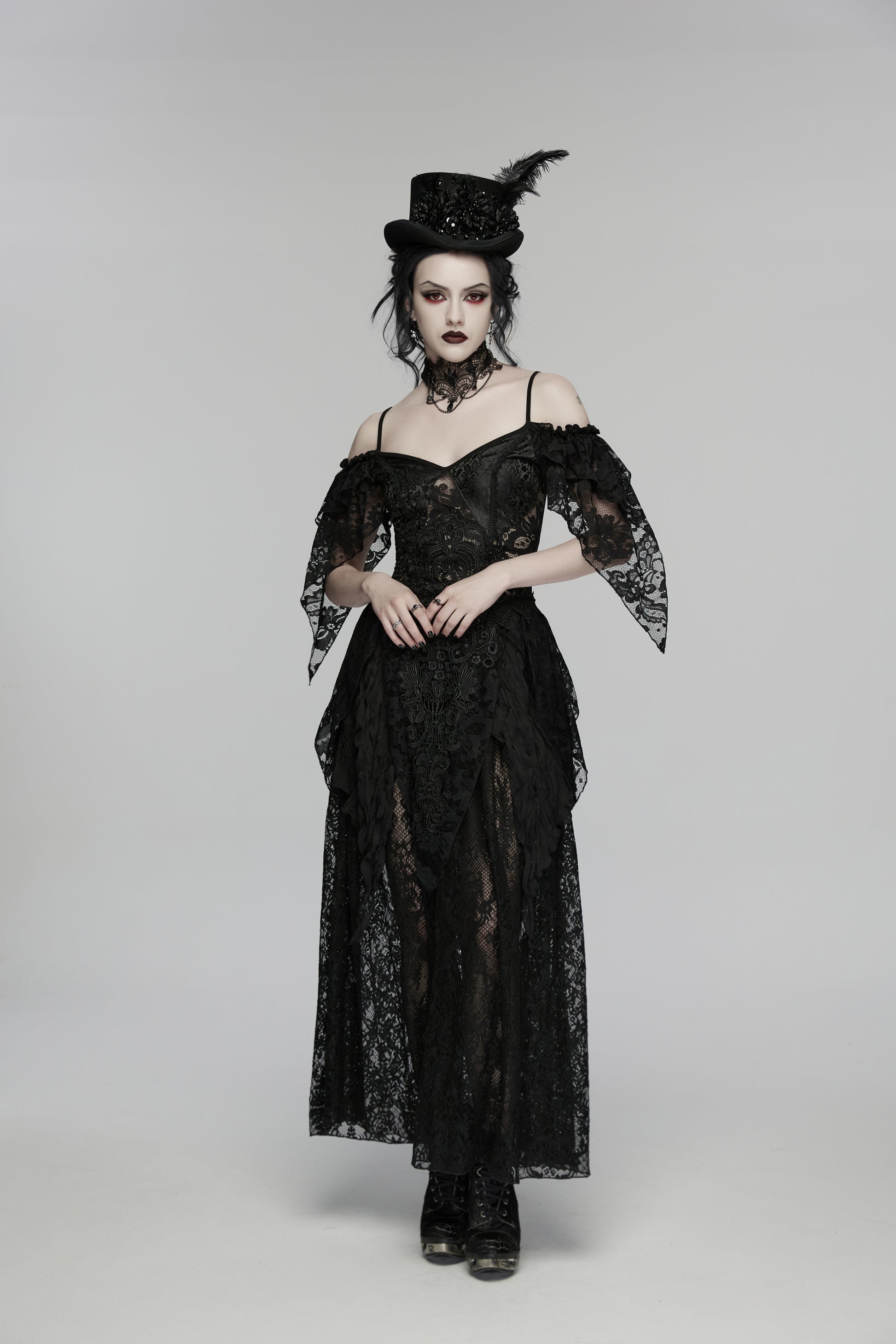 Model wearing Punk Rave Goth Retro Feather Formal Hat with black lace gown and dark makeup in a gothic setting.