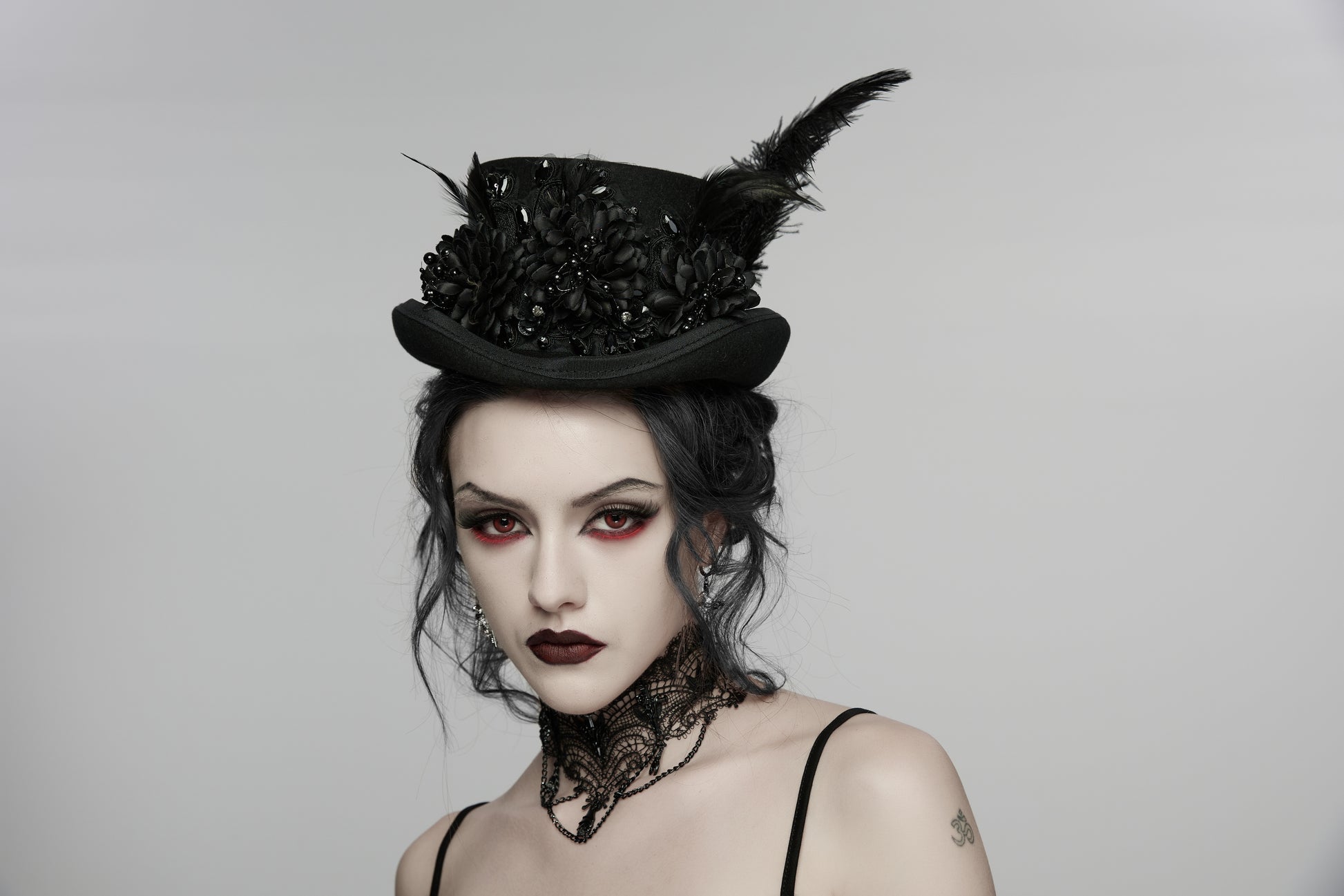 Goth feather formal hat adorned with black flowers and feathers, perfect for alternative and punk fashion.