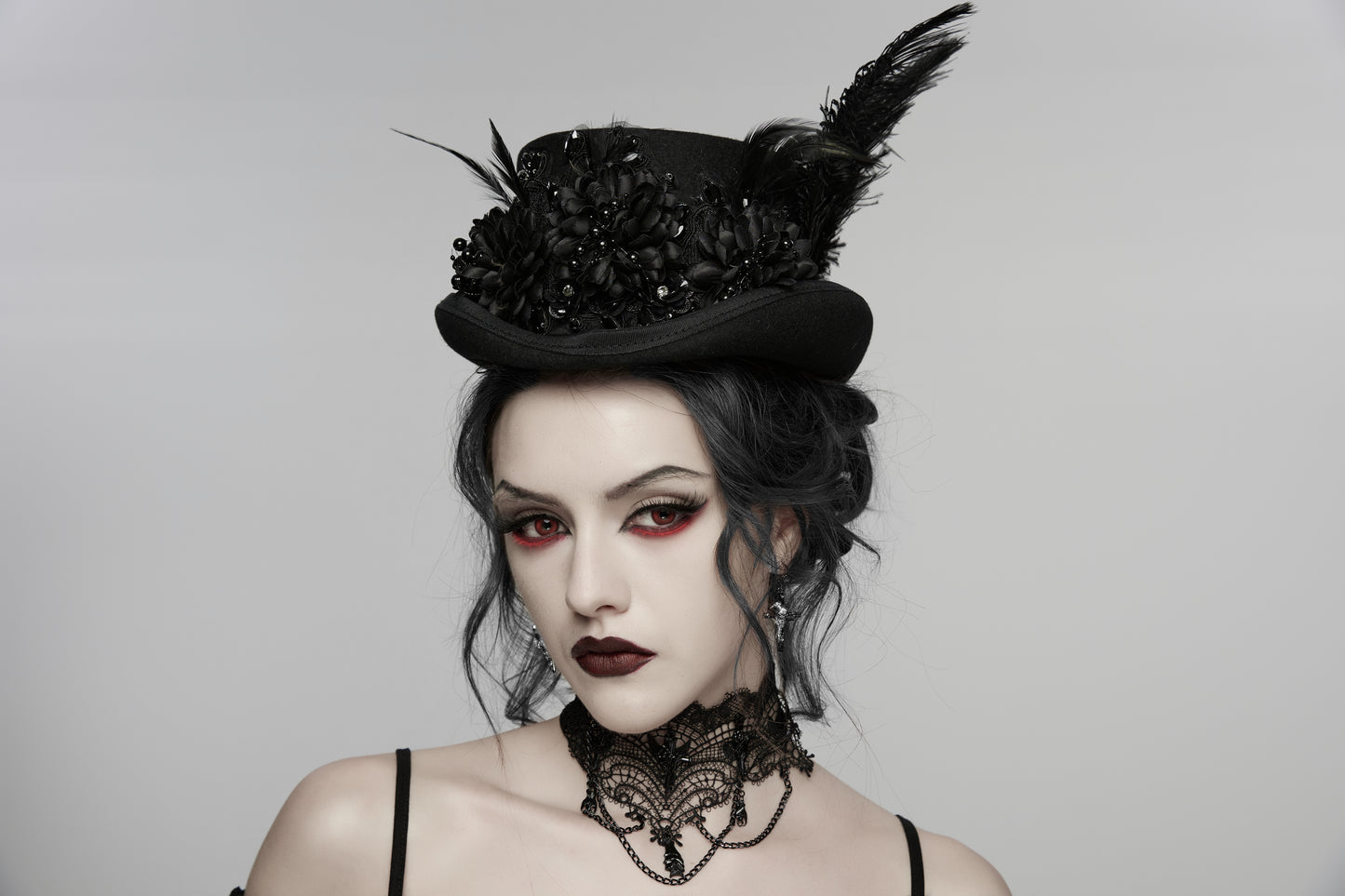 Model wearing a goth feather formal hat with floral embellishments and feathers, showcasing gothic retro style.